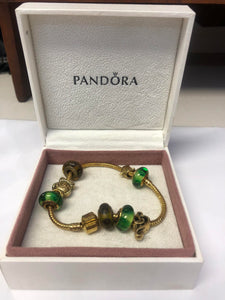Pandora gold-plated bracelet with charms