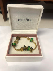 Pandora gold-plated bracelet with charms